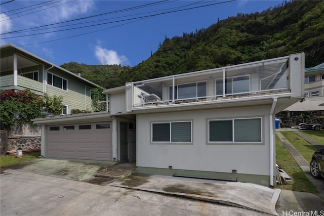 view of property featuring a balcony and a garage