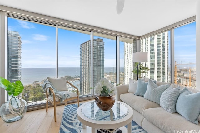 sunroom / solarium with plenty of natural light and a water view