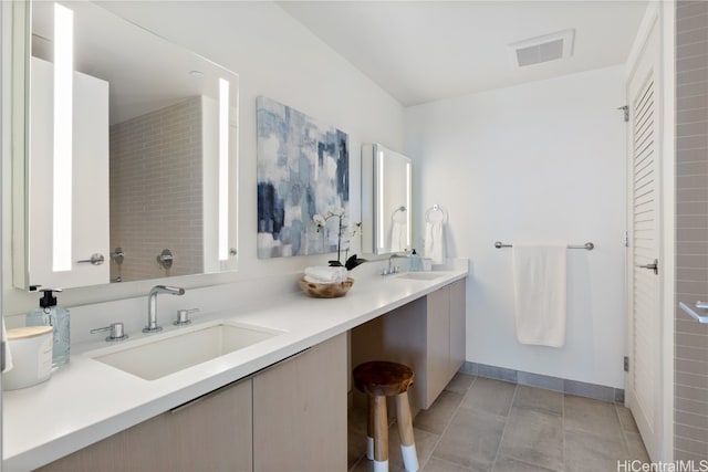 bathroom with tile patterned flooring and vanity