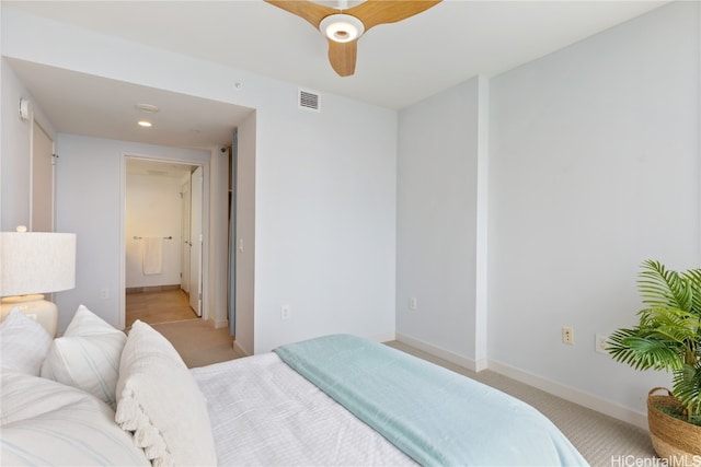 carpeted bedroom with ceiling fan and connected bathroom