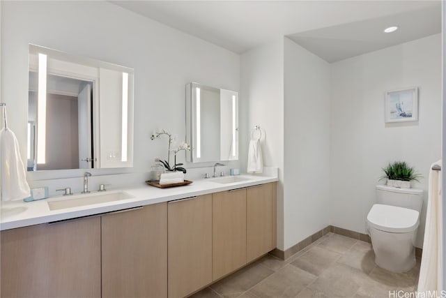 bathroom with tile patterned flooring, vanity, and toilet