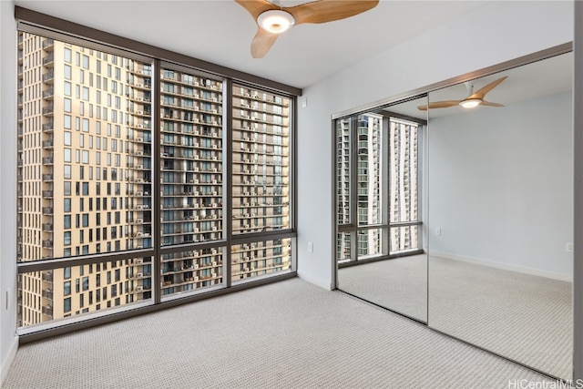 wine area featuring carpet and ceiling fan