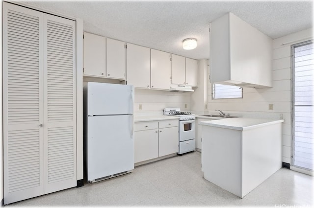 kitchen featuring sink, white cabinets, a textured ceiling, and white appliances