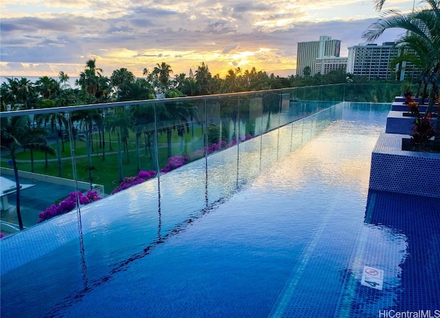 view of pool at dusk