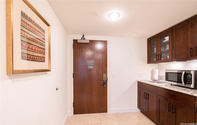 223 Saratoga Rd Unit 1006, Honolulu, HI 96815 - bar with stainless steel microwave, baseboards, and light tile patterned floors