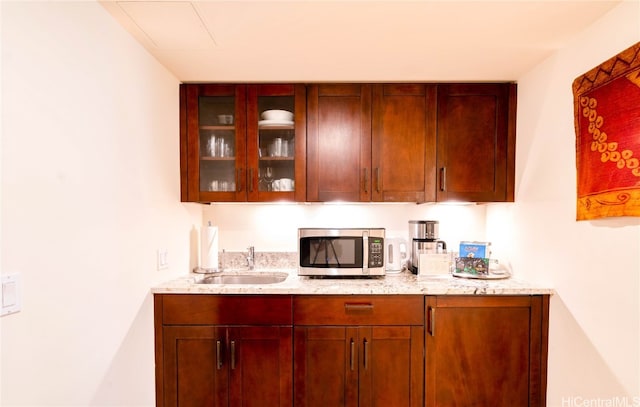 bar with light stone counters and sink