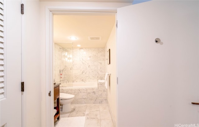 full bathroom featuring vanity, tiled shower / bath combo, toilet, and tile patterned flooring