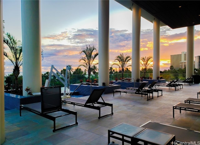 patio terrace at dusk featuring an outdoor fire pit