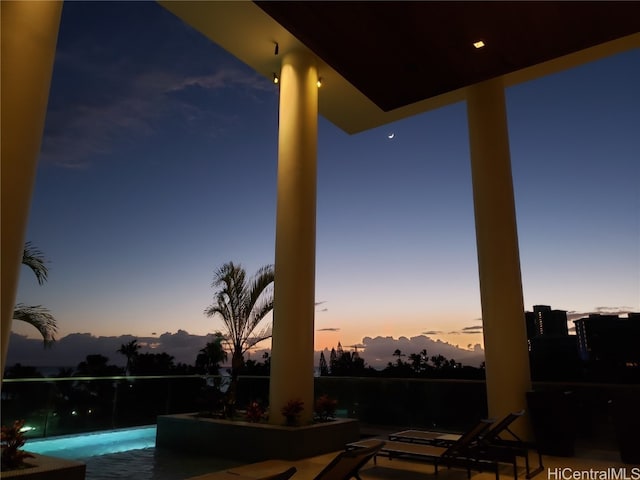 pool at dusk featuring a mountain view