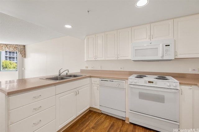 kitchen featuring white cabinetry, sink, white appliances, and kitchen peninsula