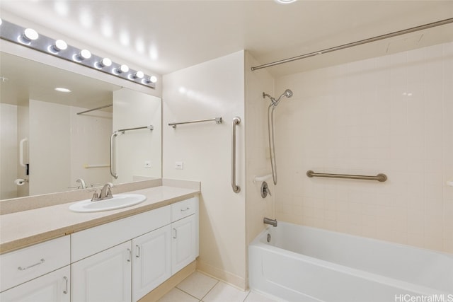 bathroom with tile patterned floors, vanity, and tiled shower / bath combo