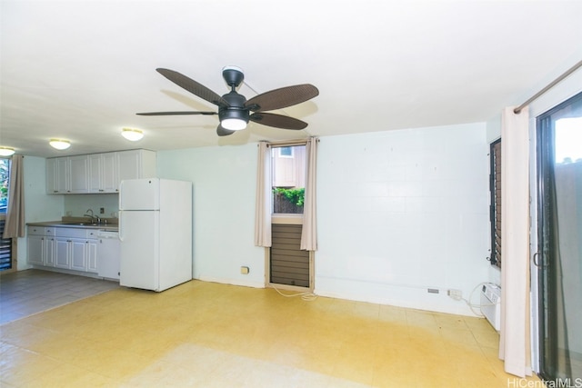 unfurnished living room featuring sink and ceiling fan