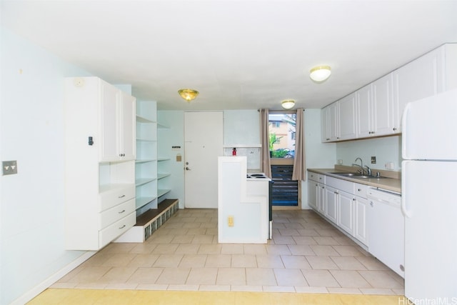 kitchen with sink, white cabinets, and white appliances