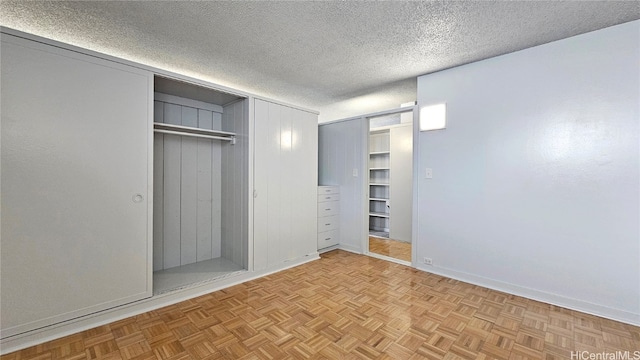 unfurnished bedroom featuring a textured ceiling and light parquet flooring