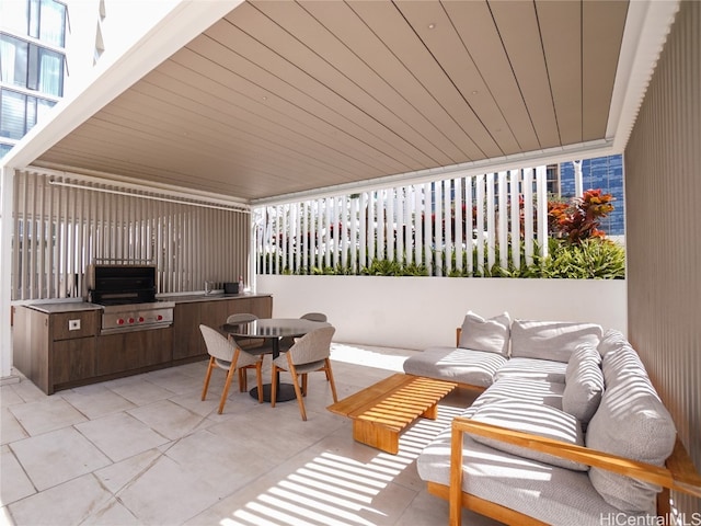 view of patio featuring an outdoor hangout area, exterior kitchen, and a grill