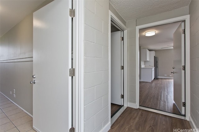 hallway featuring a textured ceiling and light wood-type flooring