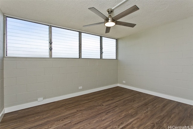 spare room featuring ceiling fan, a textured ceiling, and dark hardwood / wood-style flooring