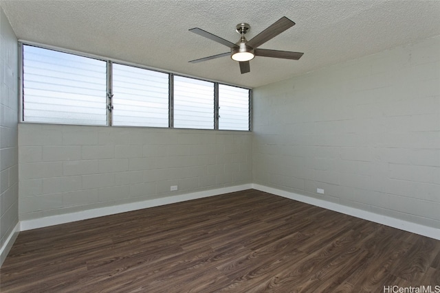 spare room with a textured ceiling, dark hardwood / wood-style floors, and ceiling fan