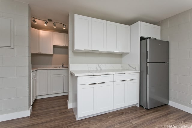 kitchen featuring white cabinetry, dark hardwood / wood-style flooring, and stainless steel fridge