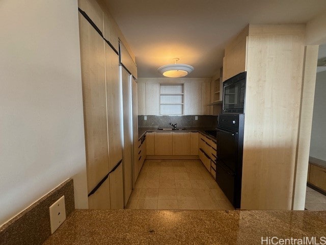 kitchen with tasteful backsplash, black appliances, sink, and light brown cabinetry