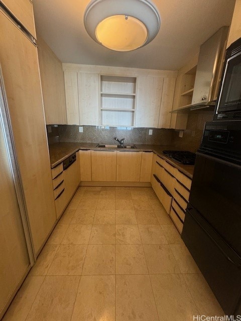 kitchen featuring gas stovetop, light brown cabinets, oven, wall chimney exhaust hood, and sink