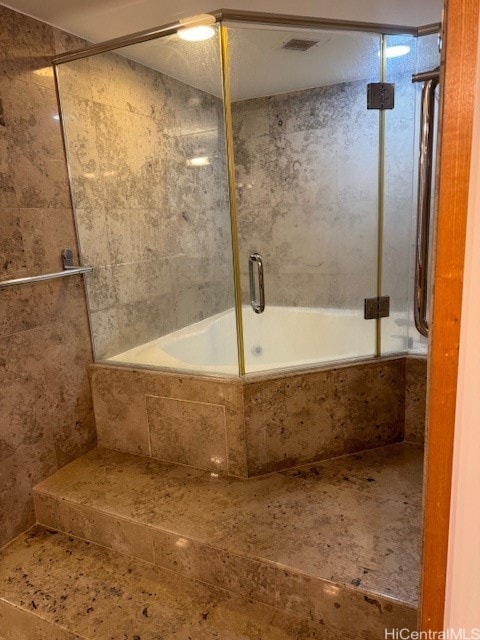 bathroom with shower / bath combination with glass door