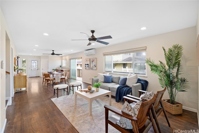 living room featuring dark wood-type flooring, ceiling fan, and a wall mounted AC