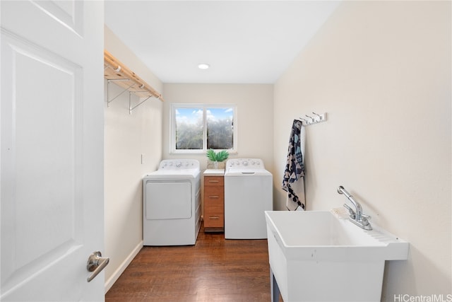 laundry area with washer and dryer, sink, and dark hardwood / wood-style floors