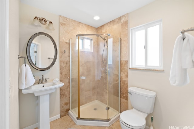 bathroom featuring tile patterned floors, toilet, and walk in shower