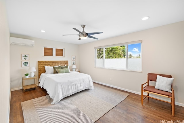 bedroom with dark hardwood / wood-style floors, an AC wall unit, and ceiling fan