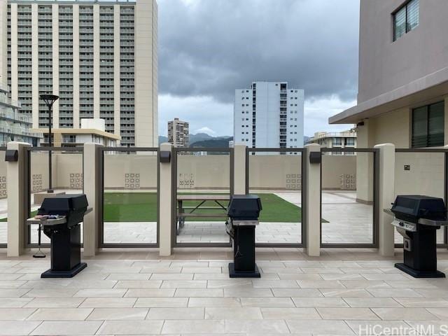 exterior space with a city view and area for grilling