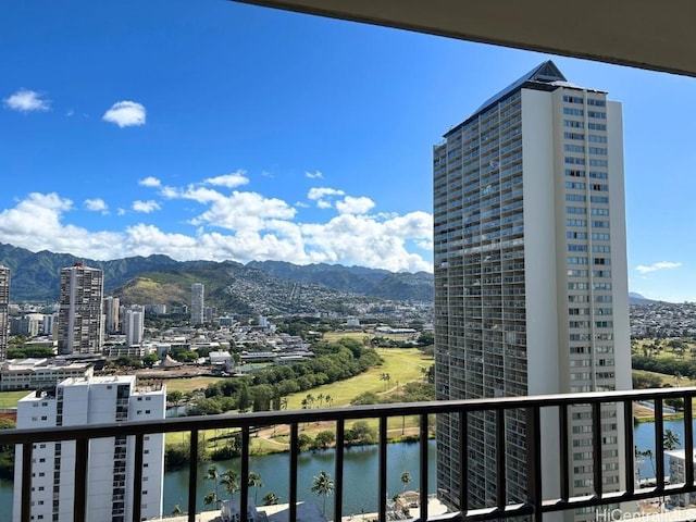 balcony featuring a water and mountain view