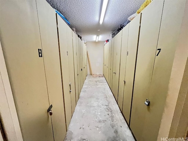 hallway with a textured ceiling