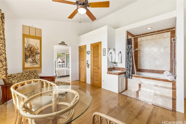 sitting room with light hardwood / wood-style flooring, ceiling fan, and vaulted ceiling