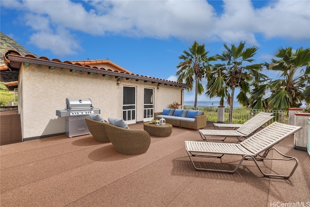 view of patio with an outdoor living space and a grill