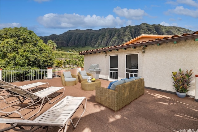 view of patio / terrace featuring an outdoor living space and a mountain view