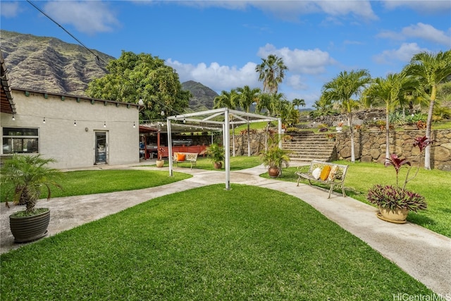 view of yard with a mountain view and a carport