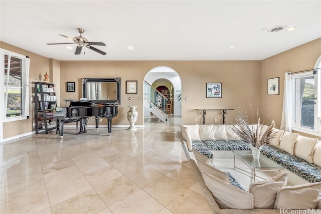 living room with ceiling fan and a wealth of natural light