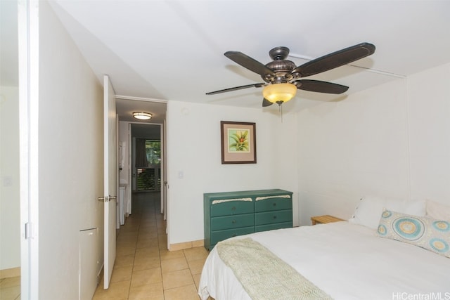 tiled bedroom featuring ceiling fan