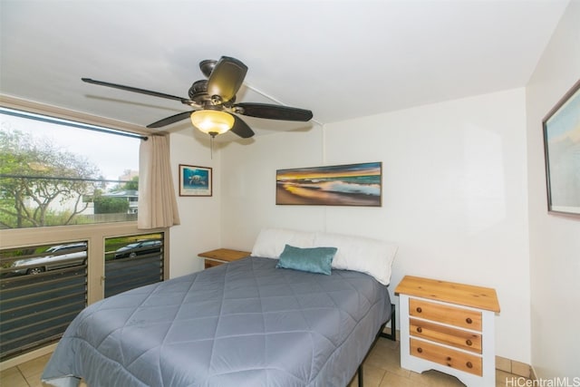 tiled bedroom featuring ceiling fan