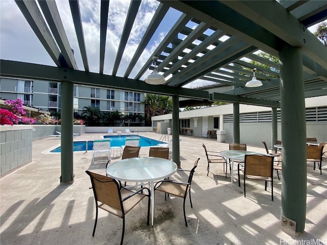 view of patio / terrace with a community pool and a pergola