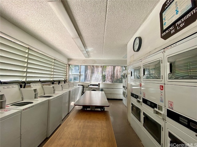 laundry area featuring a textured ceiling, washing machine and dryer, stacked washer and clothes dryer, and dark colored carpet