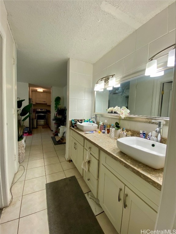 bathroom featuring vanity, a textured ceiling, and tile patterned flooring