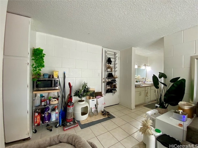 living room featuring a textured ceiling and light tile patterned floors