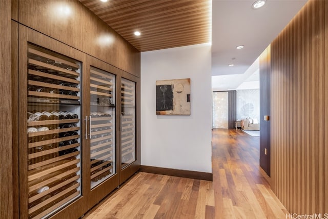 wine area featuring wooden ceiling and light hardwood / wood-style flooring