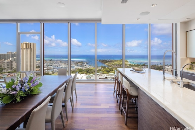 unfurnished sunroom with a water view and sink