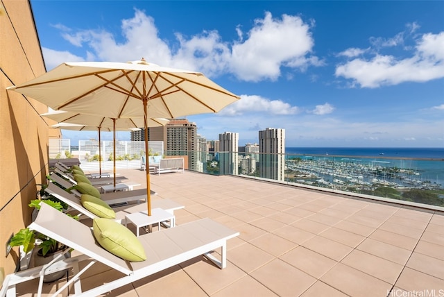 view of patio / terrace with a water view and a balcony