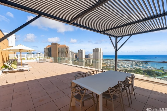 view of patio with a water view and a pergola