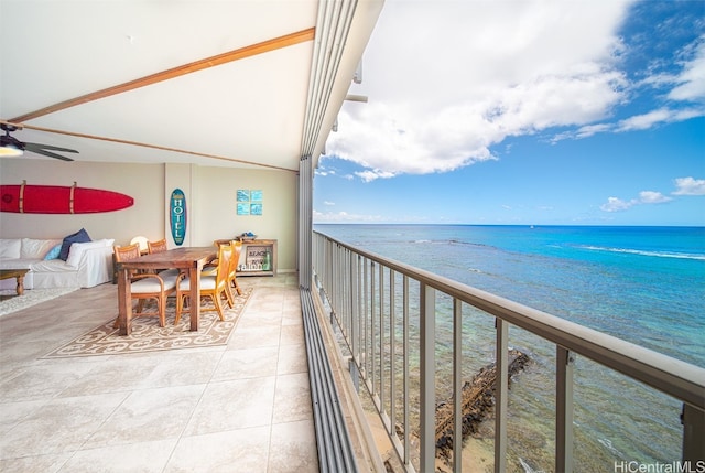 balcony featuring a water view and a beach view