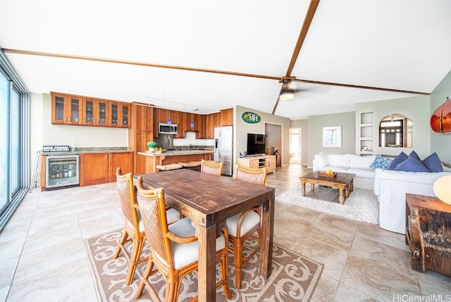 dining room with built in shelves, beverage cooler, and ceiling fan